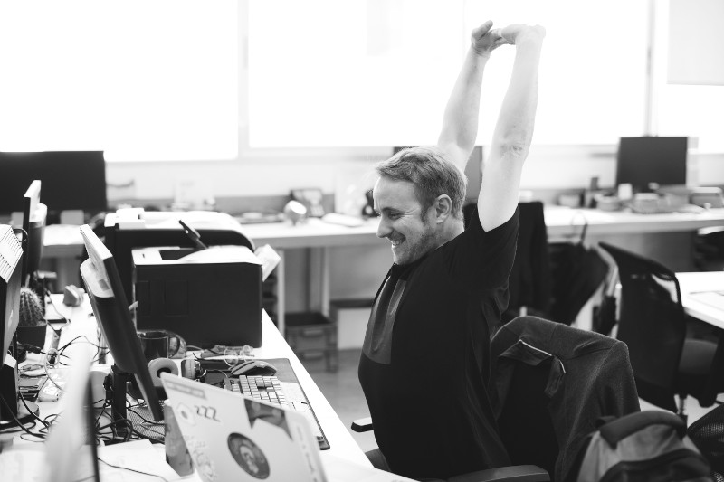 Happy developer sitting in front of a computer